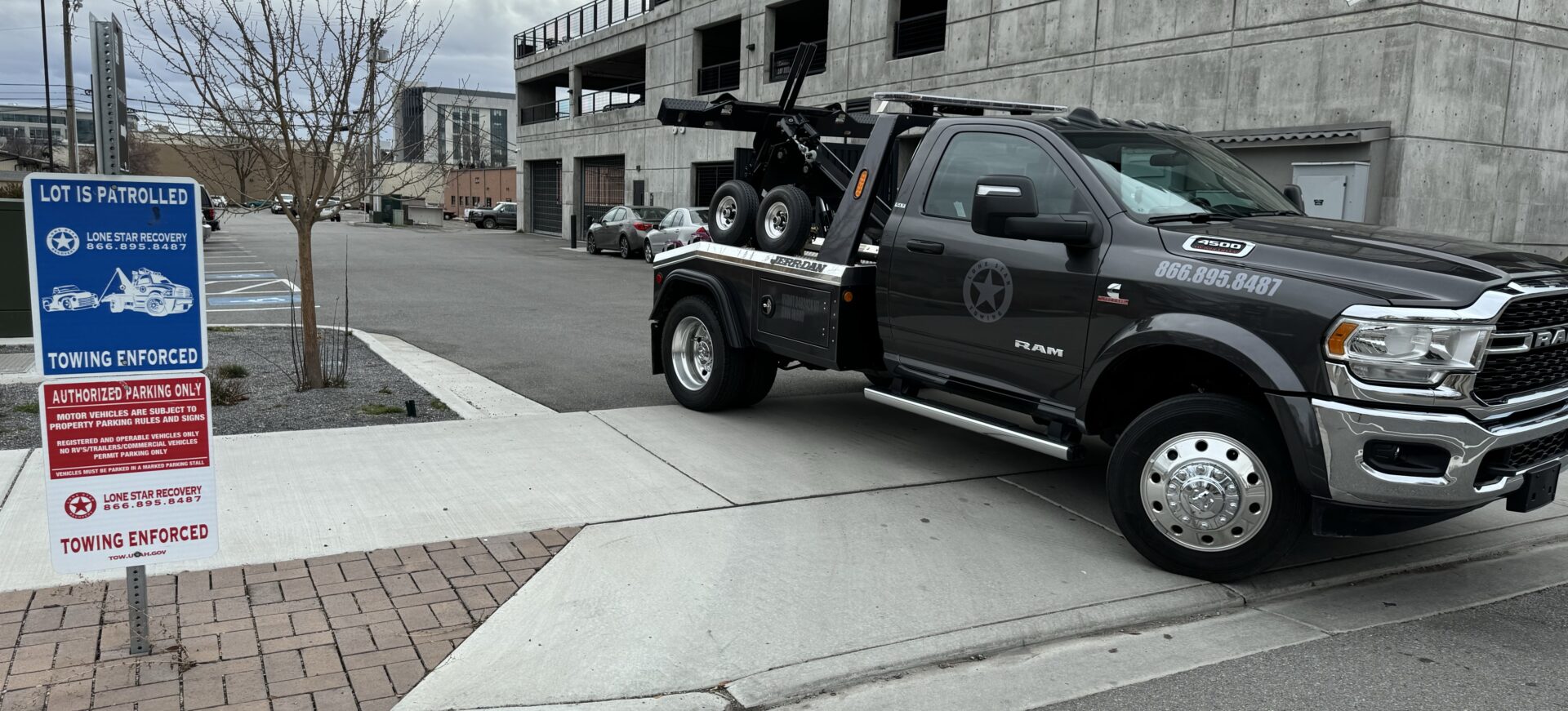 A tow truck parked on the side of a road.