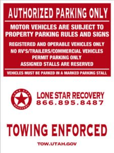 A red and white sign that says towing enforced.